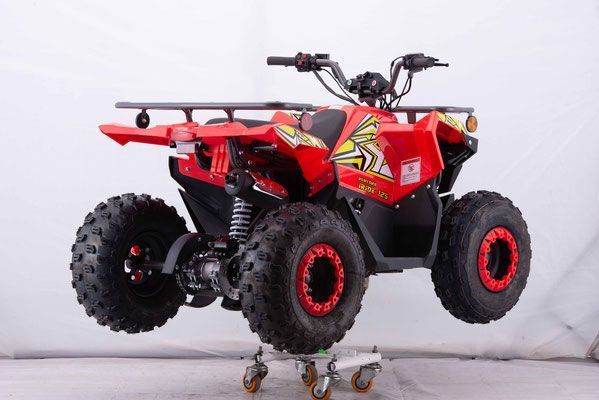A red atv is sitting on top of a cart.
