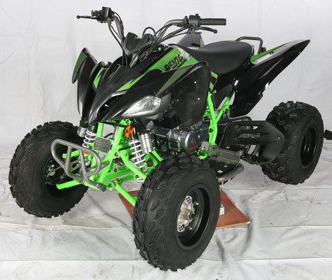 A green and black atv is sitting on a table.