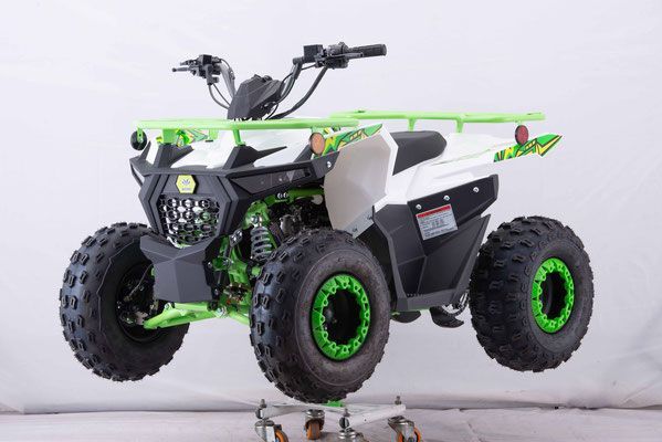 A white and green atv is sitting on a cart.