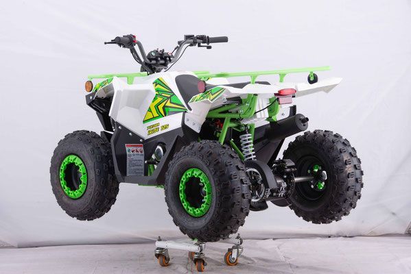 A green and white atv is sitting on a cart.