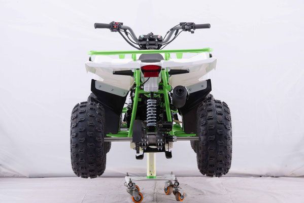A green and white atv is sitting on a stand.