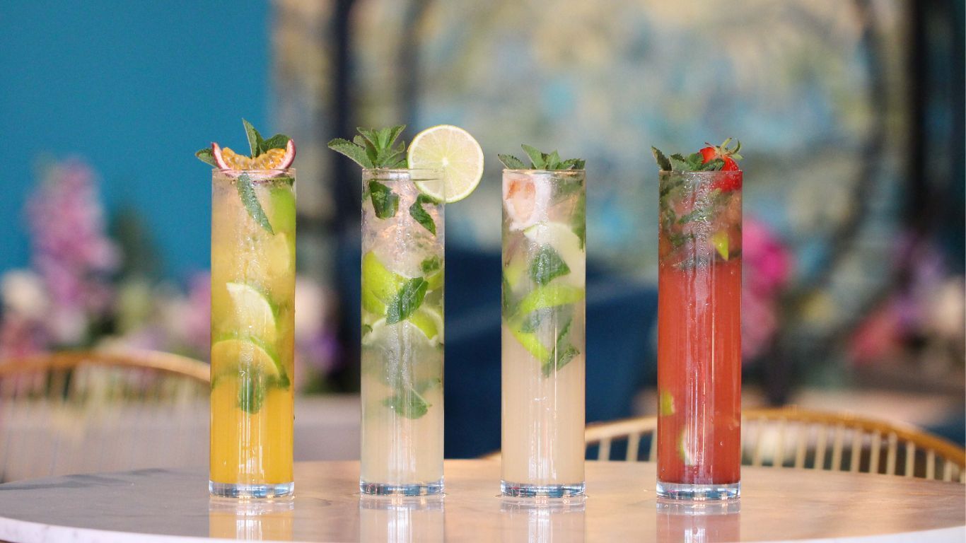 A table topped with four different types of drinks.