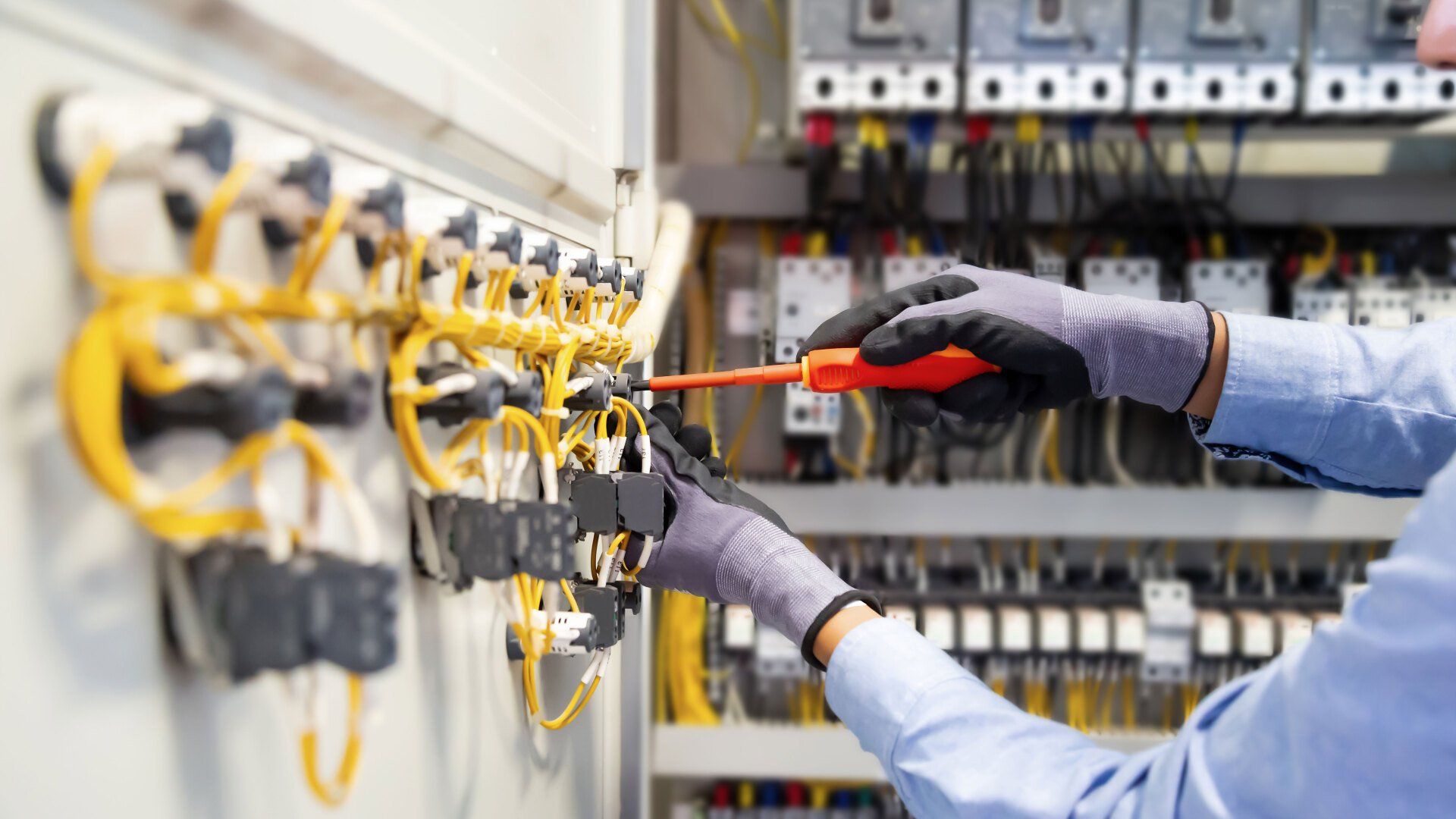 Hand of a worker holding a screwdriver