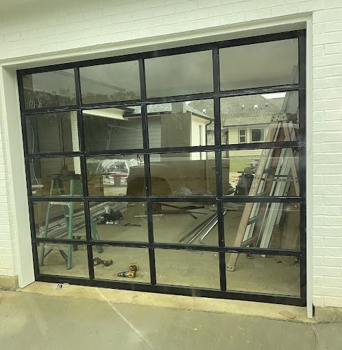 A garage door with a lot of windows is being built.
