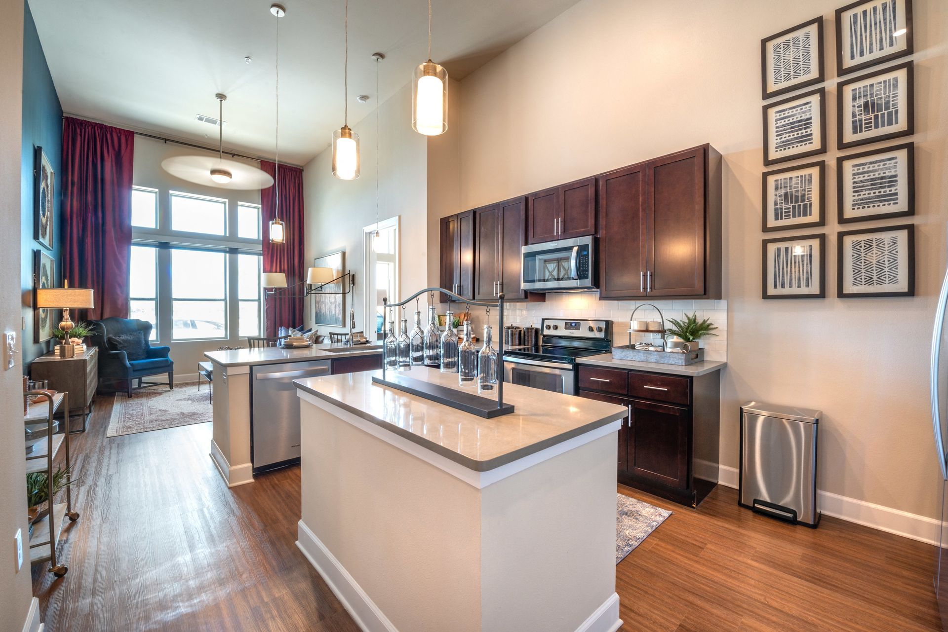A kitchen with a large island and stainless steel appliances.