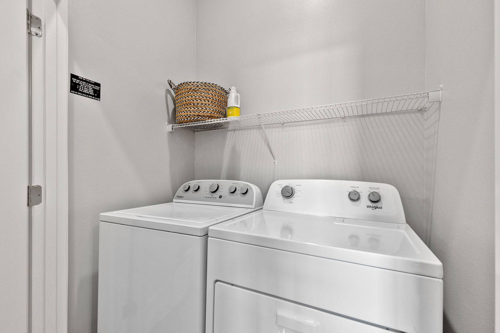A laundry room with a washer and dryer in it.