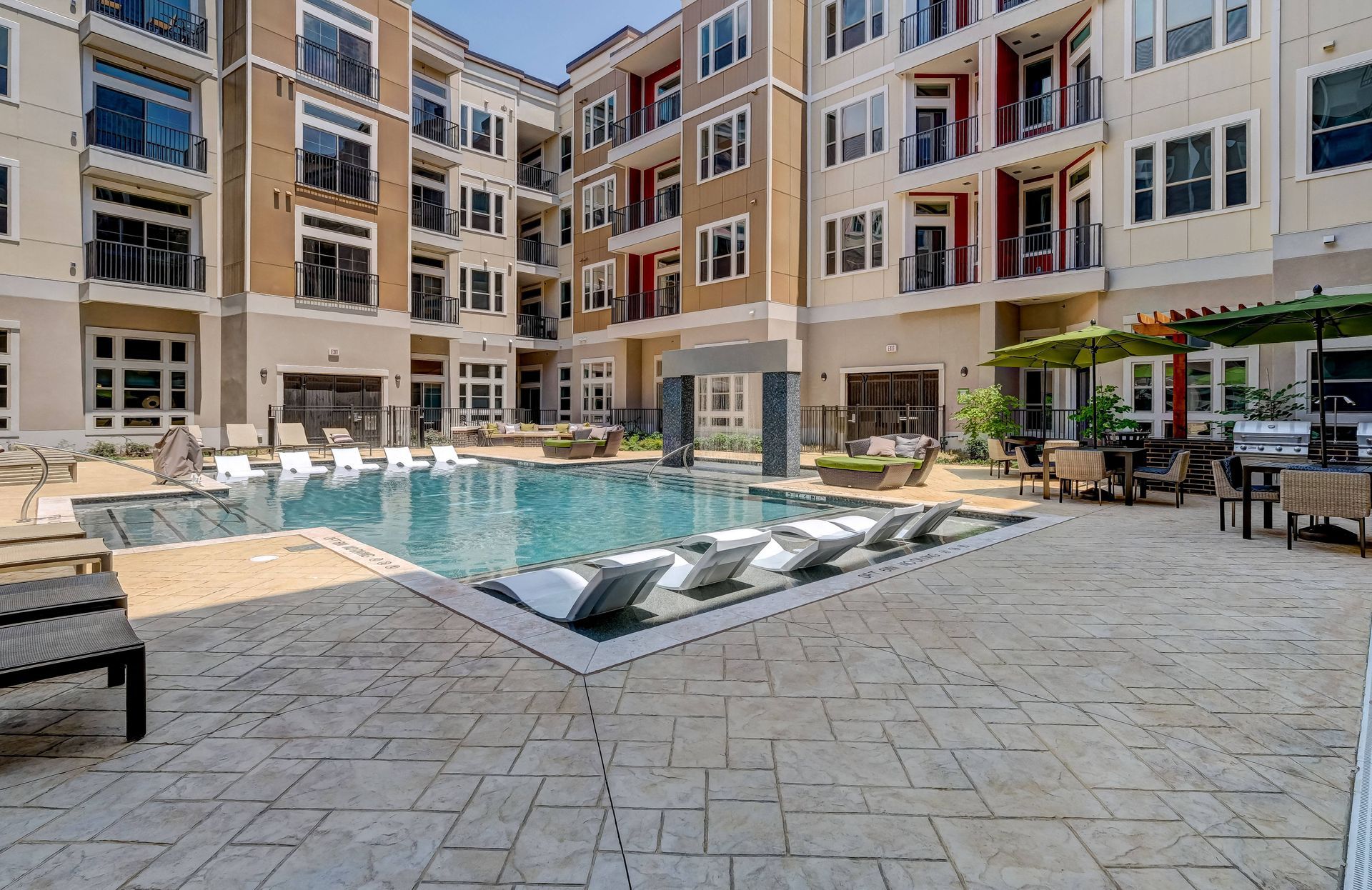 There is a large swimming pool in the middle of a building.