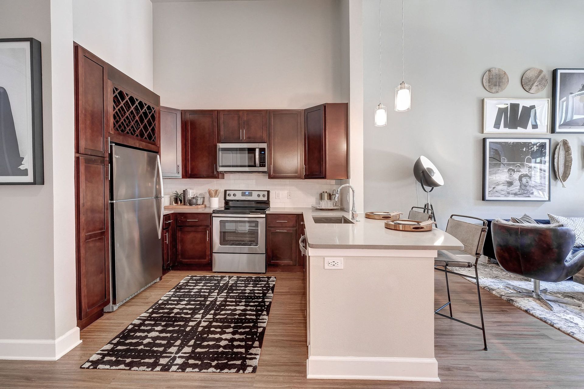 A kitchen with stainless steel appliances and wooden cabinets.
