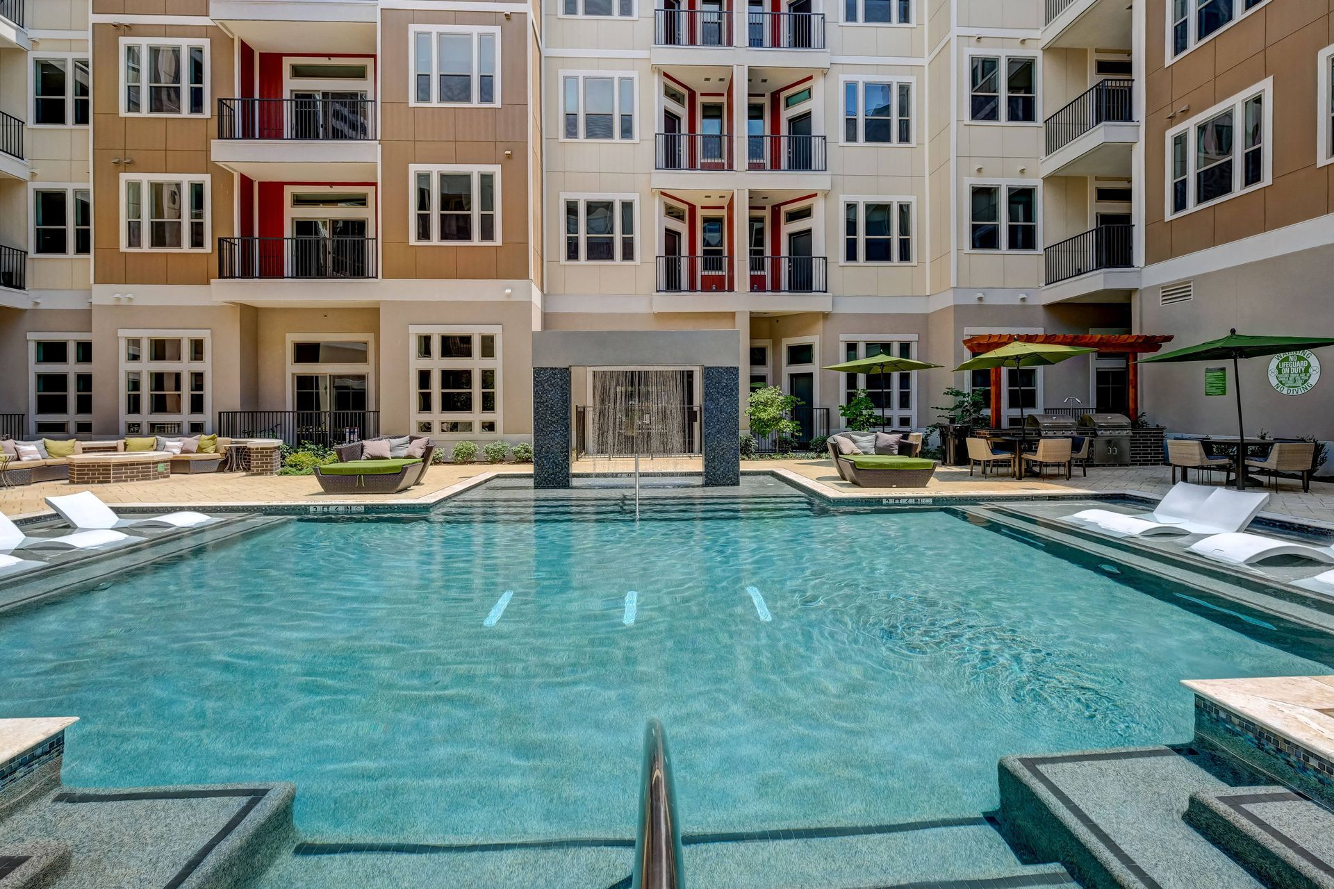 There is a large swimming pool in the middle of a building.