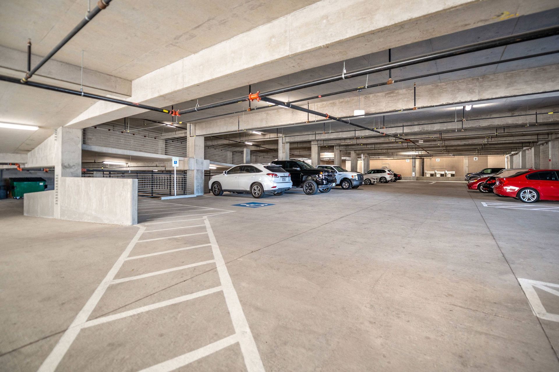 A lot of cars are parked in a parking garage.