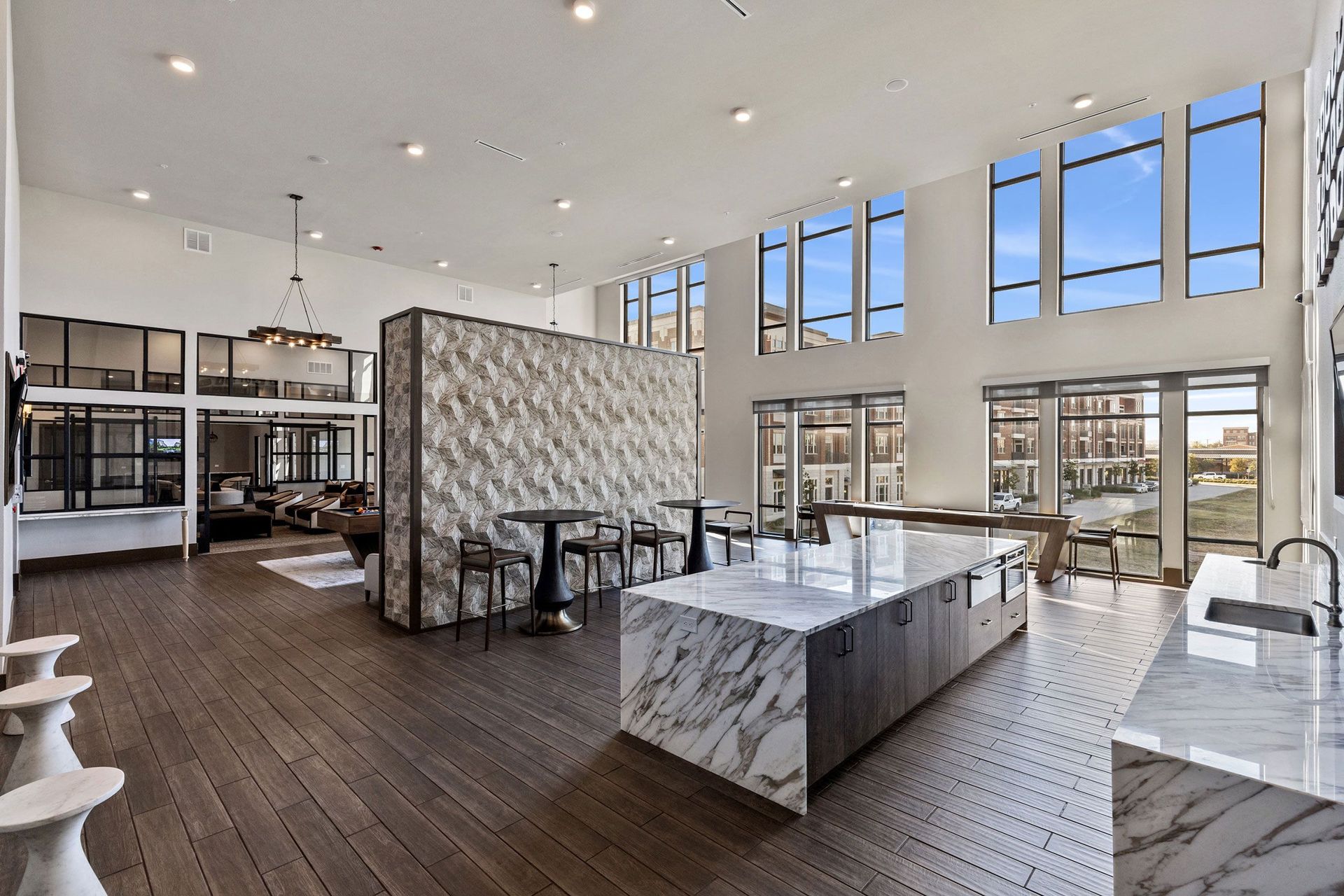 A large room with a lot of windows and tables and chairs.