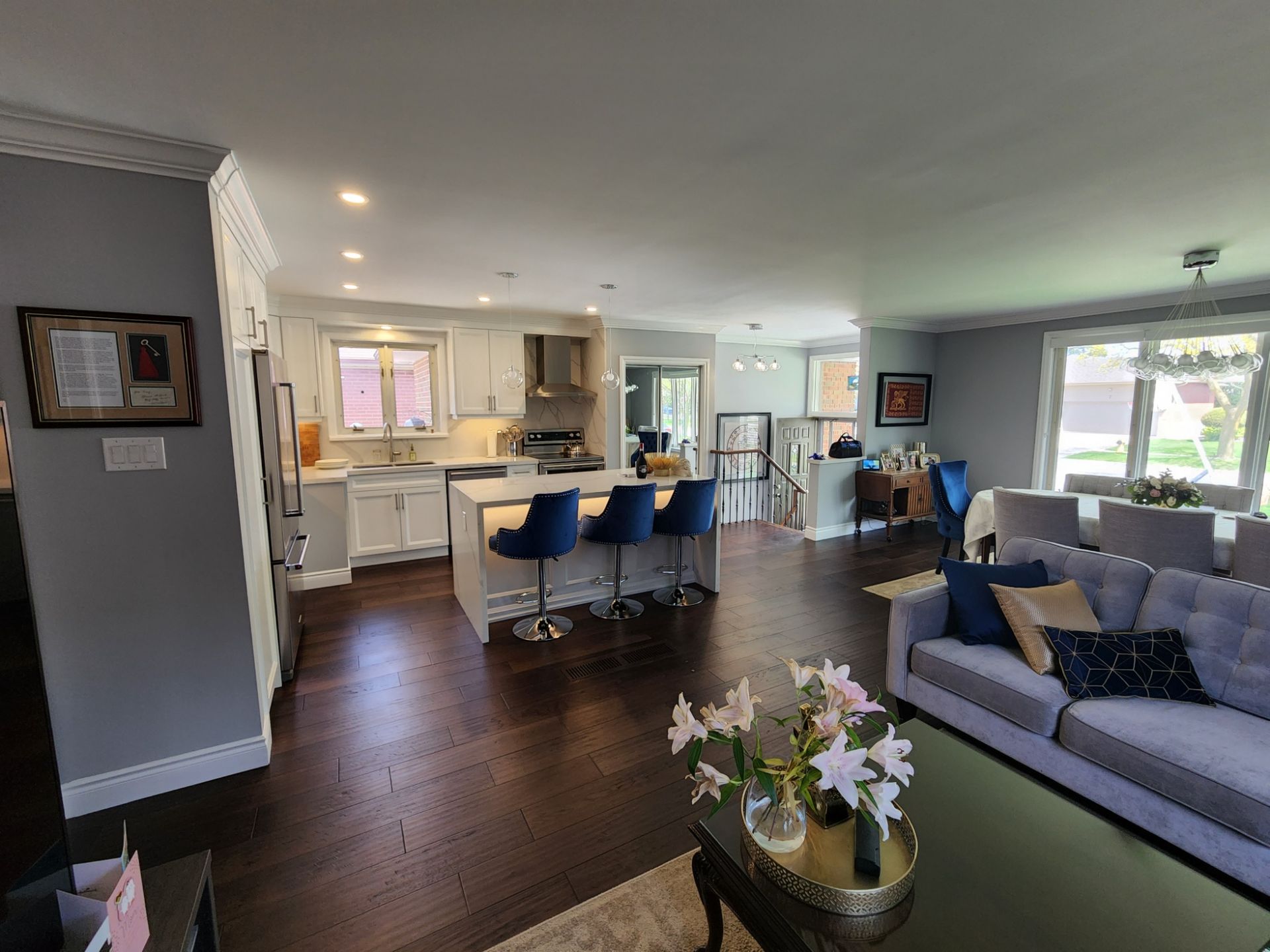 A living room filled with furniture and a kitchen in a house.