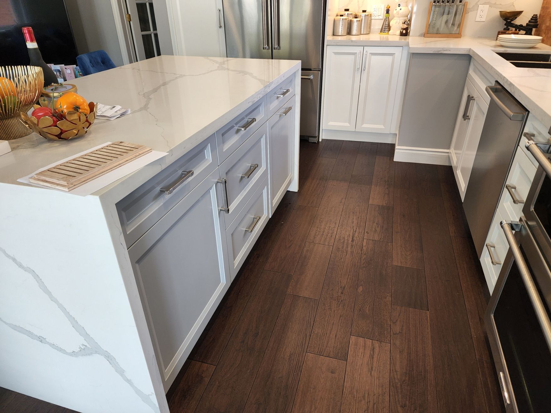 A kitchen with white cabinets and stainless steel appliances