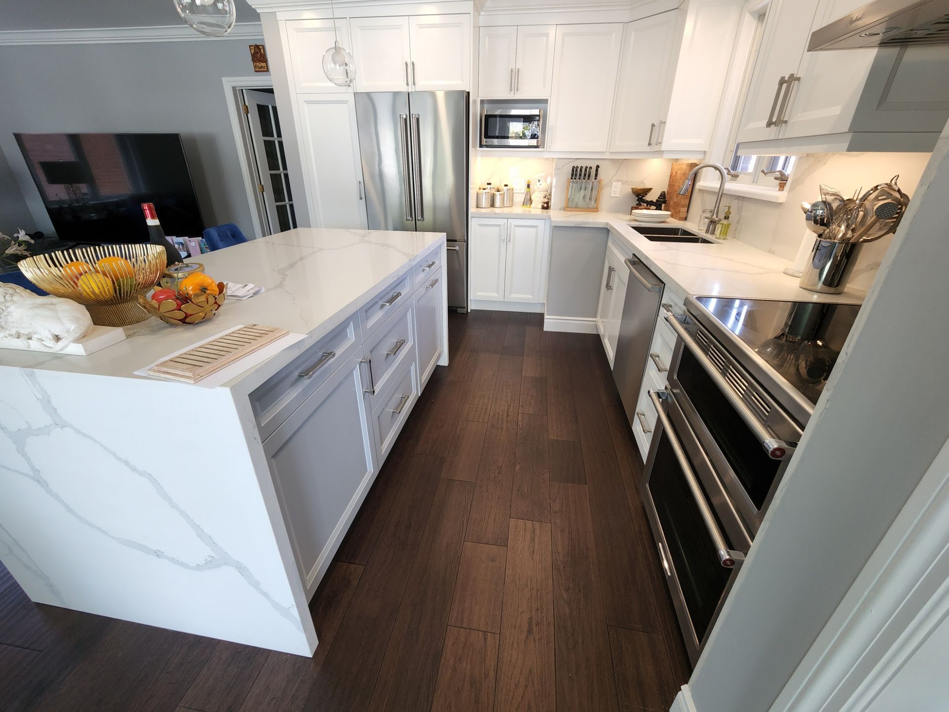 A kitchen with white cabinets and stainless steel appliances
