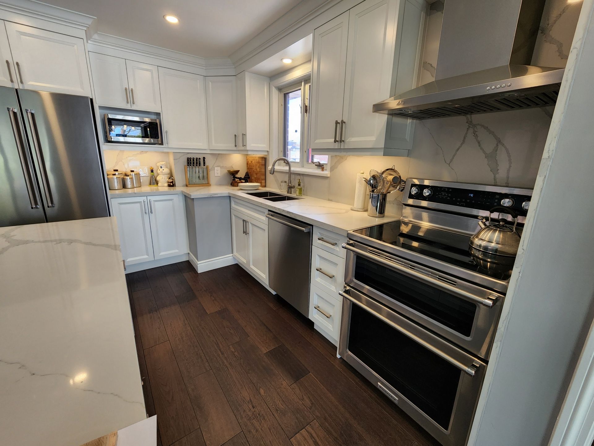 A kitchen with stainless steel appliances and white cabinets