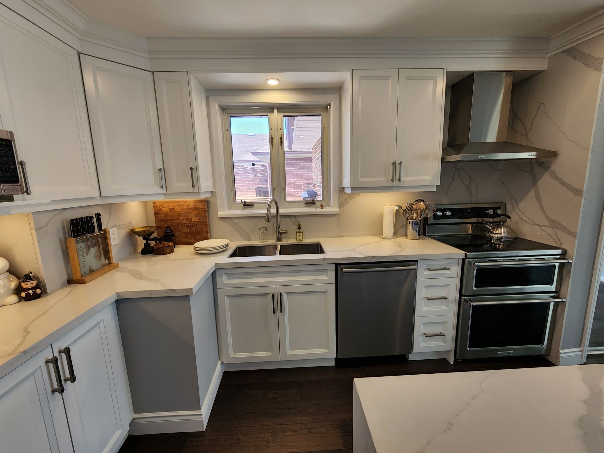 A kitchen with white cabinets and stainless steel appliances