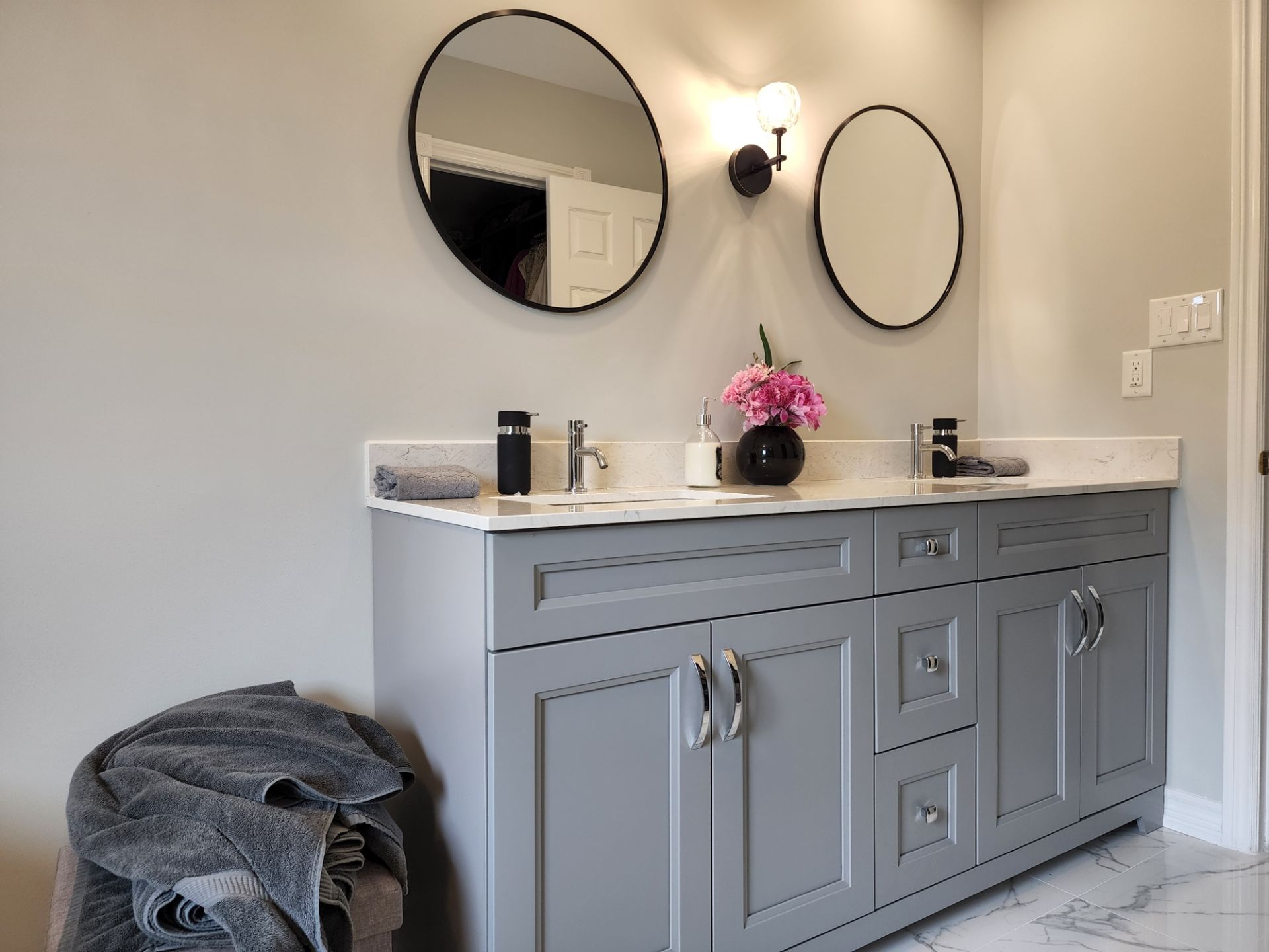 A bathroom with two sinks and two mirrors on the wall.