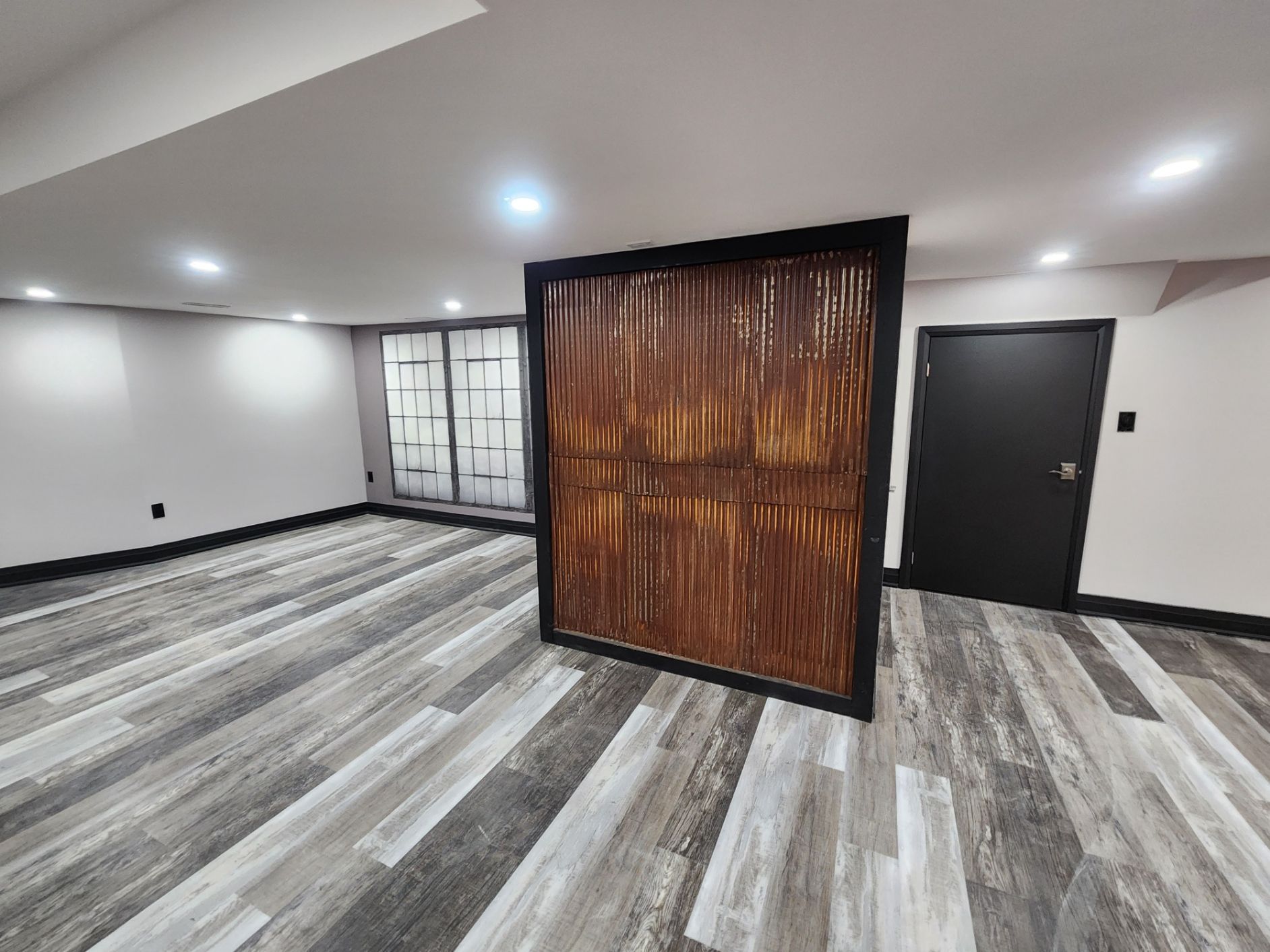 A room with a wooden wall and a wooden floor.