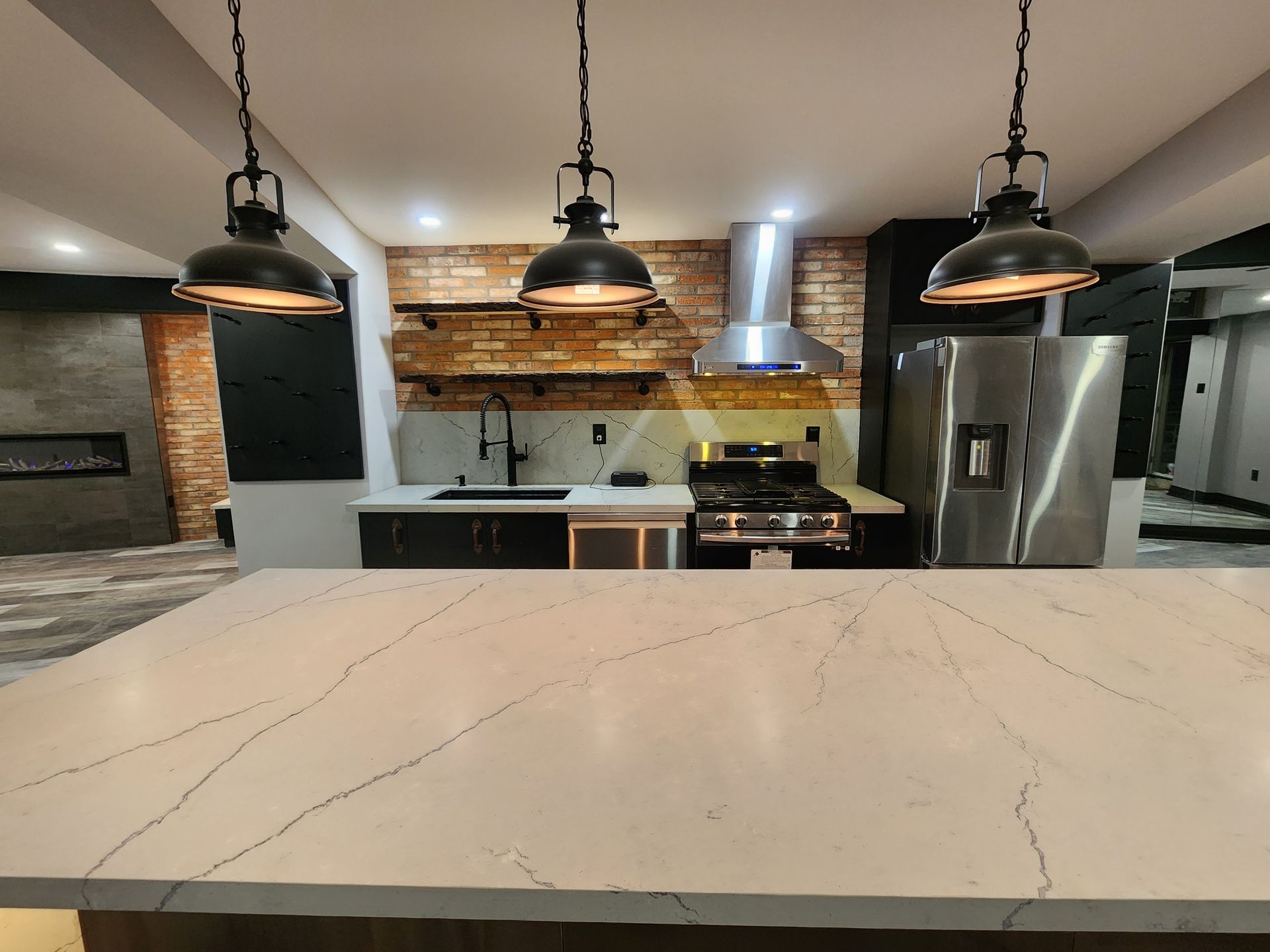 A kitchen with stainless steel appliances and a white counter top