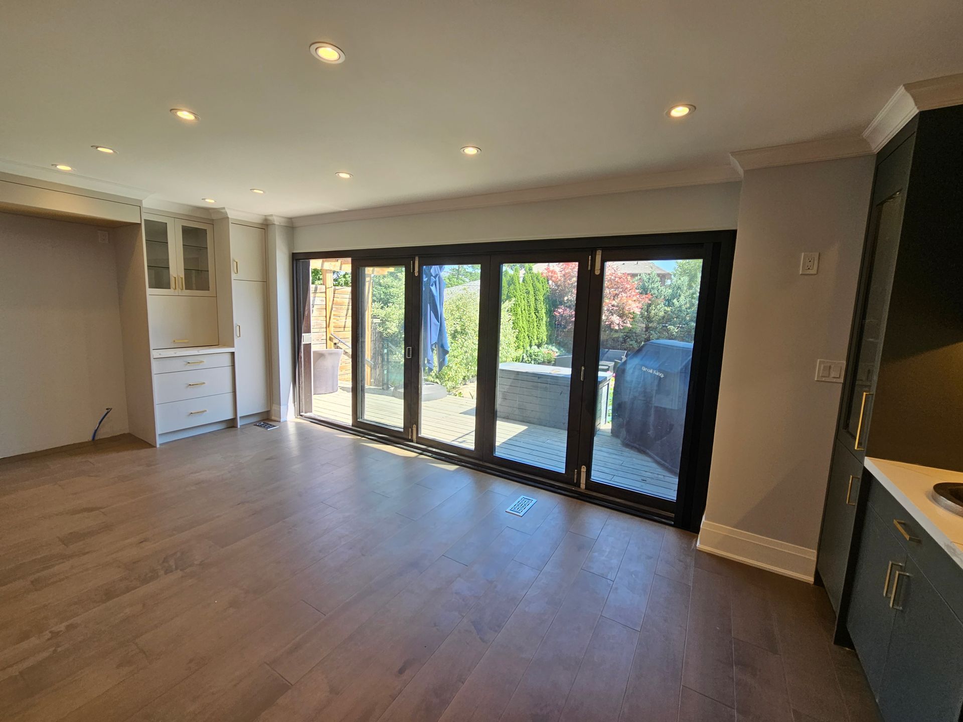 An empty living room with sliding glass doors leading to a patio.