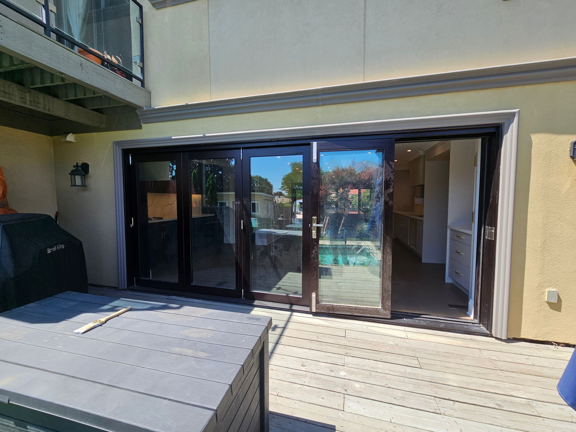 A house with sliding glass doors leading to a pool.