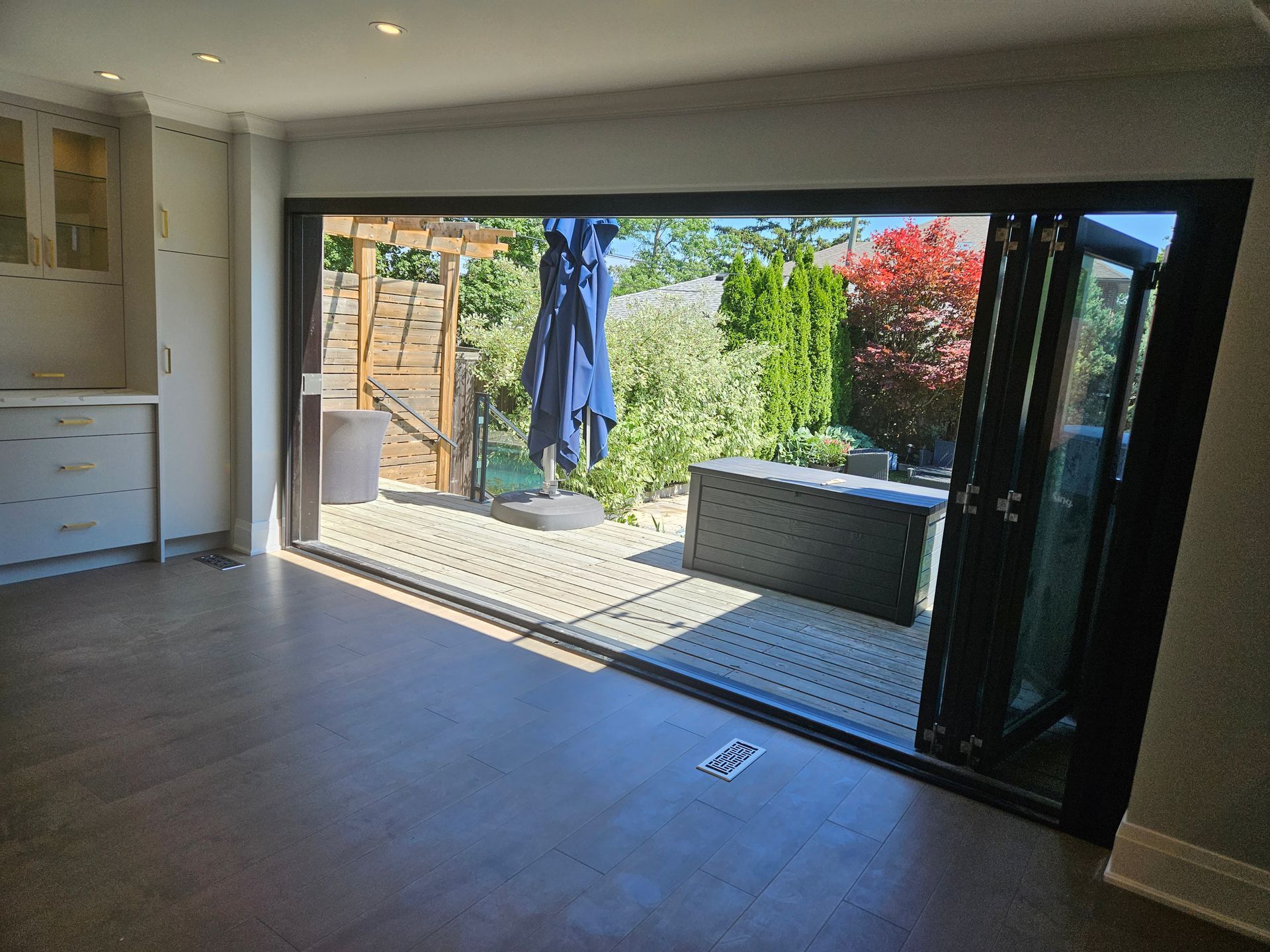 A room with a sliding glass door leading to a deck.