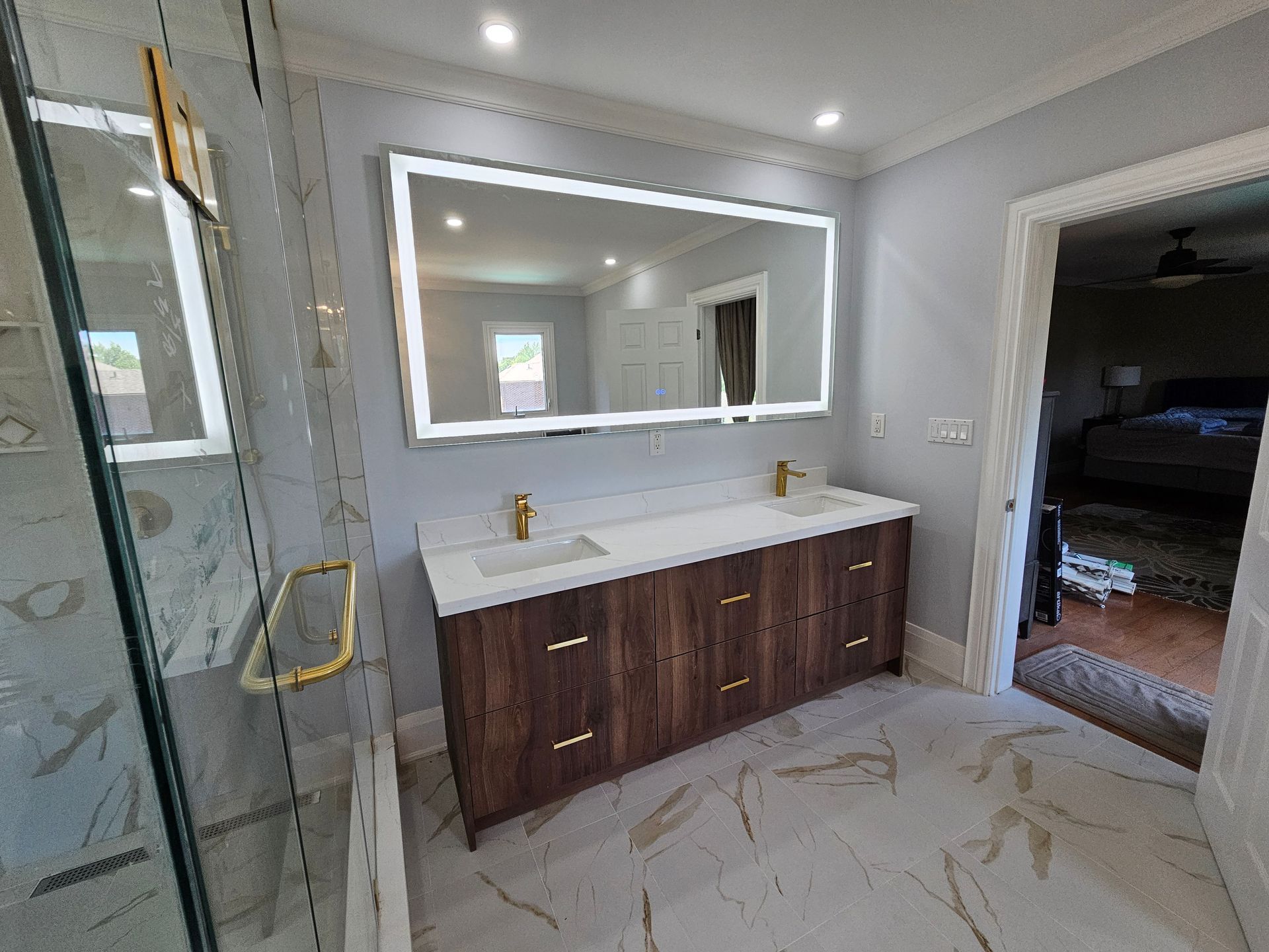 A bathroom with a double sink and a large mirror.