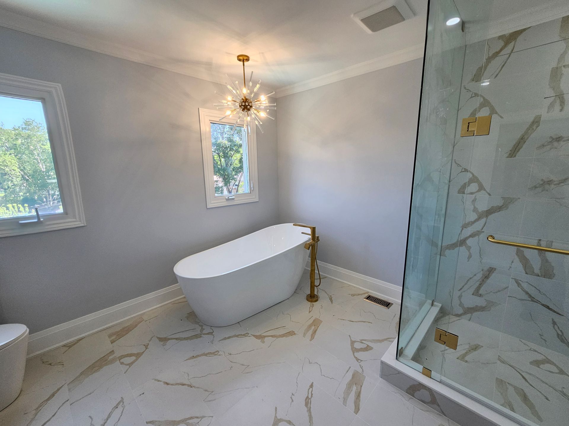 A bathroom with a bathtub and a walk in shower.