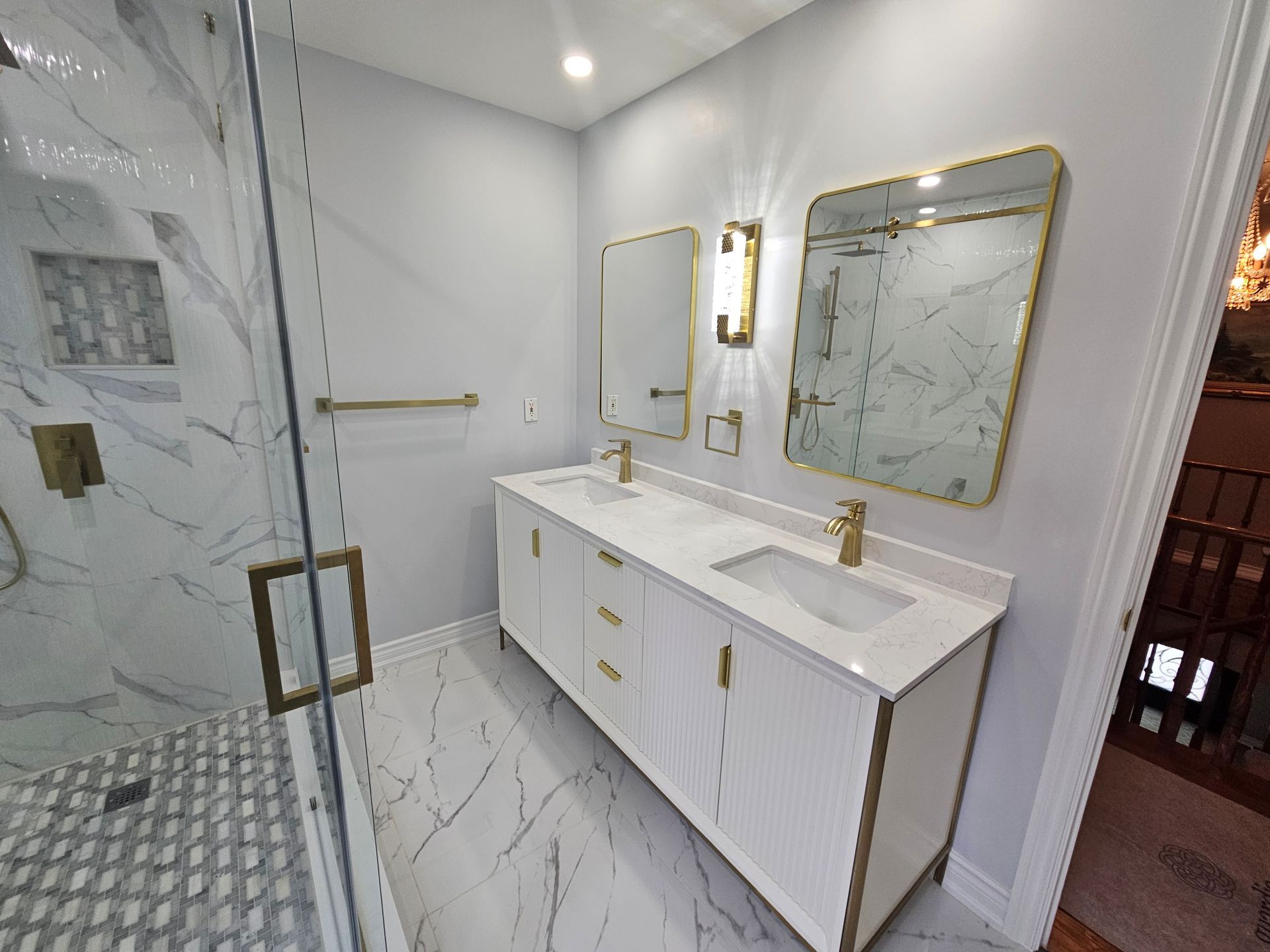 A bathroom with two sinks and a walk in shower.