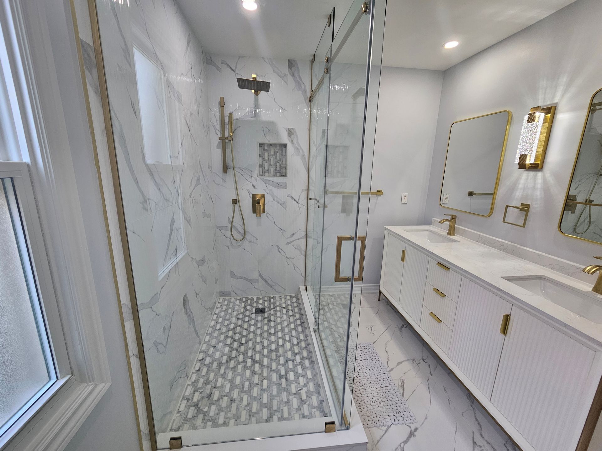 A bathroom with a walk in shower and two sinks.