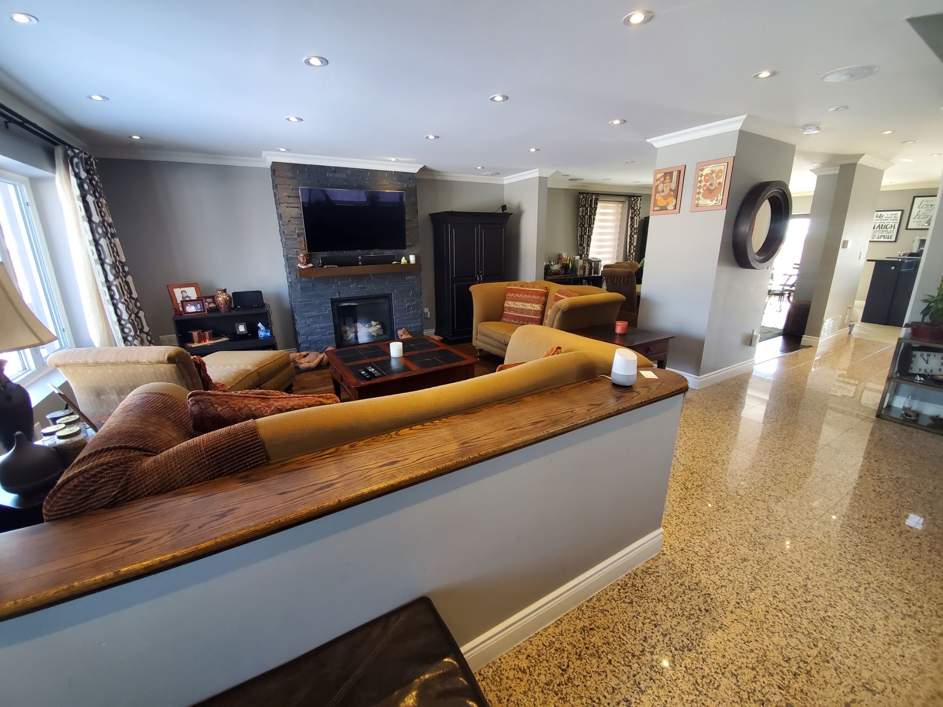 A kitchen with a glass table and chairs and a trash can.