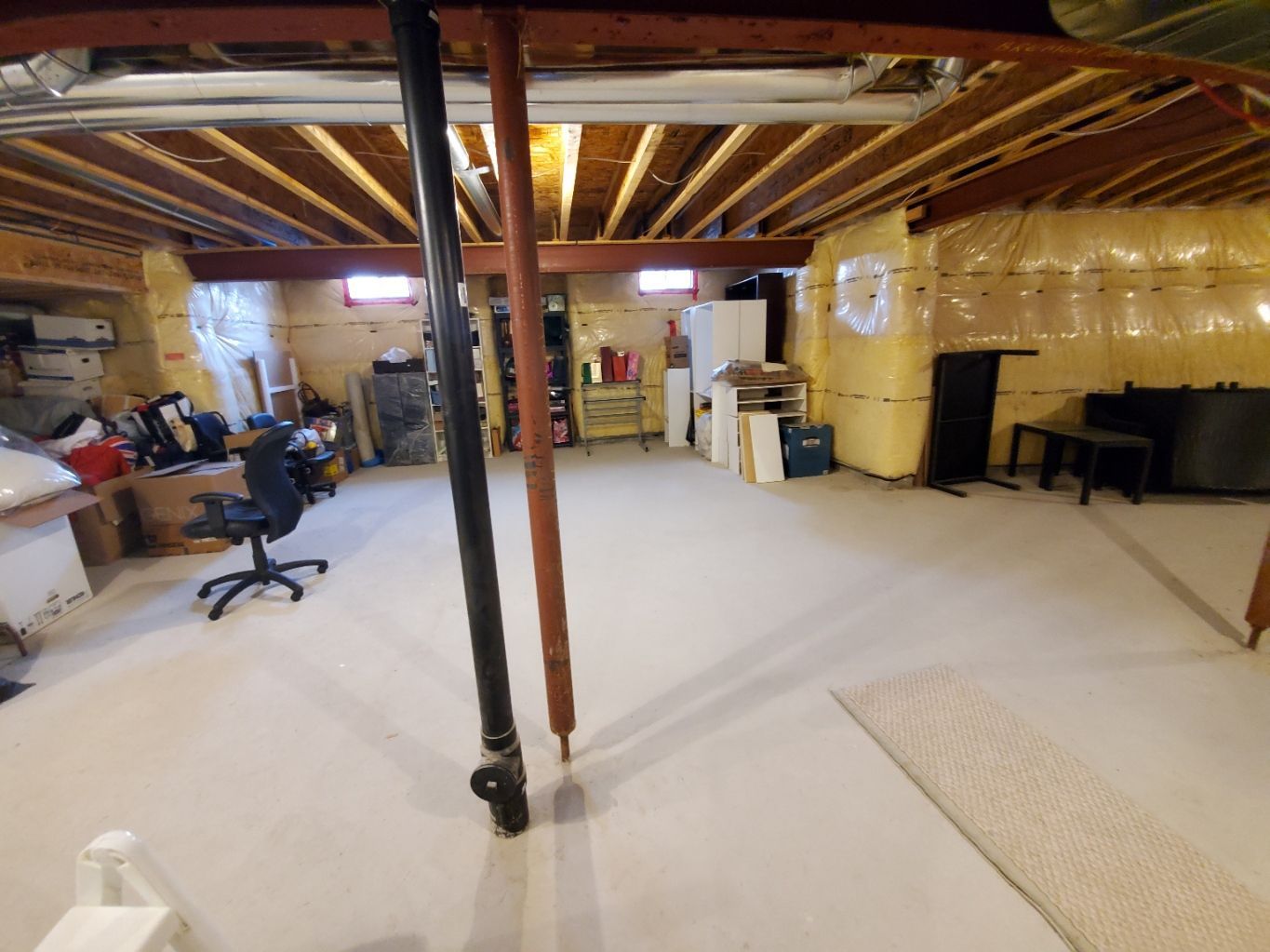 A basement with a lot of boxes and wooden walls.