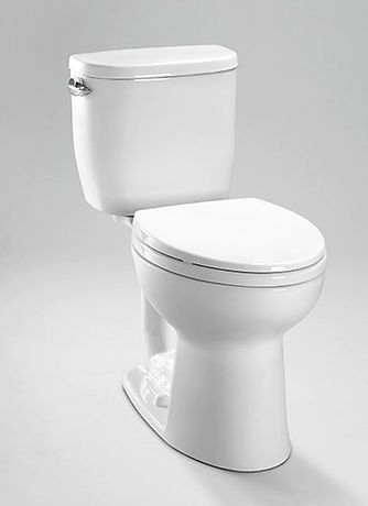 A white toilet is sitting on a white surface.