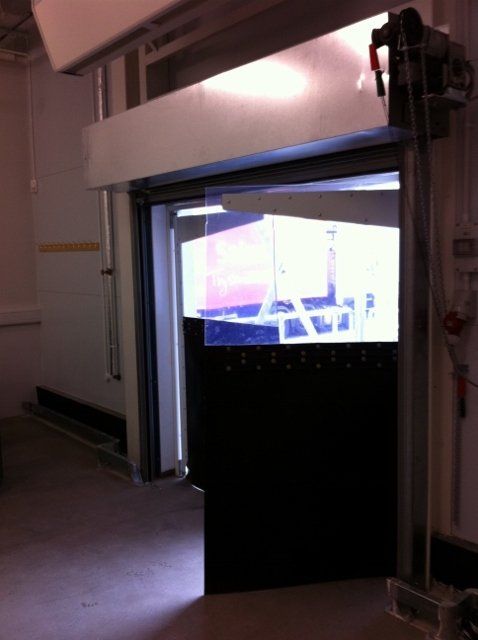 A door that is open in a dark room