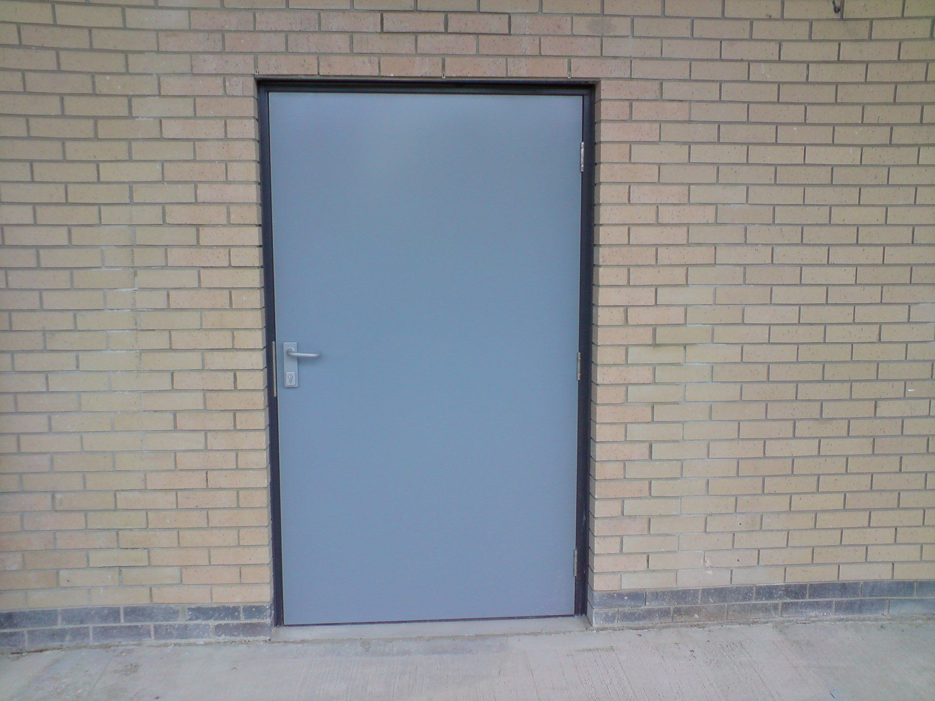 A brick wall with a door in it