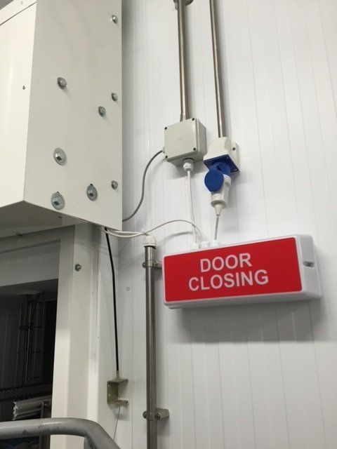 A red sign that says door closing on it