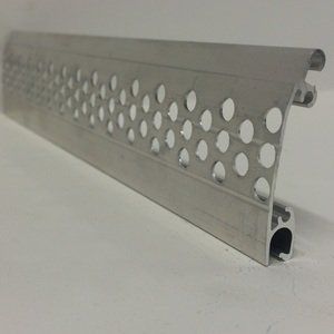 A piece of metal with holes in it is sitting on a white surface.