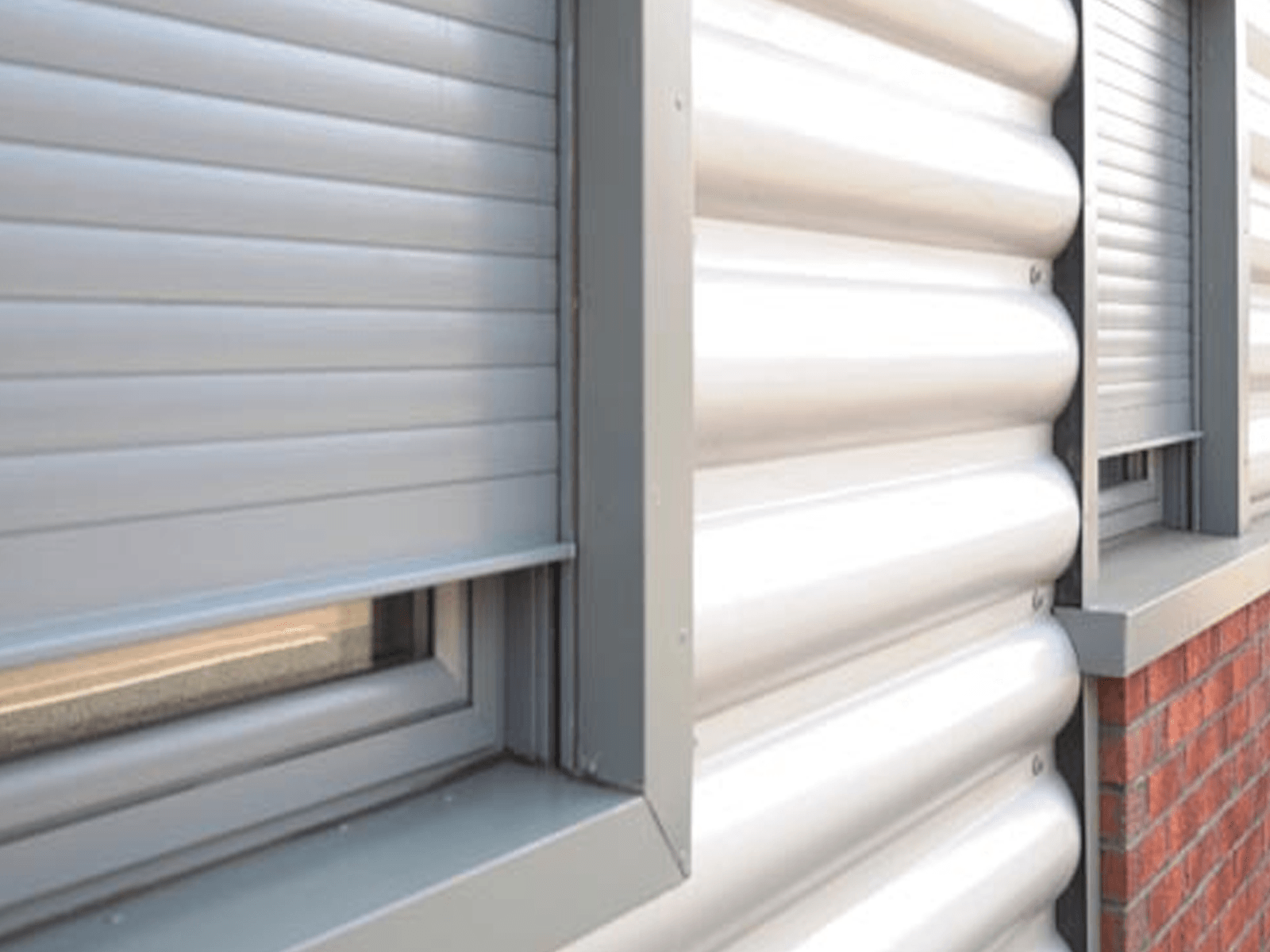 A close up of a window with a roller shutter on it.