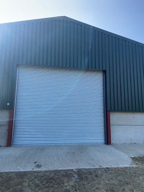 There is a large garage door on the side of a building.