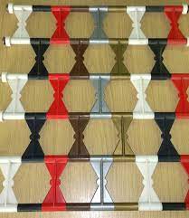 A bunch of different colored plastic sticks are stacked on top of each other on a wooden table.