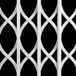 A close up of a white gate on a black background.