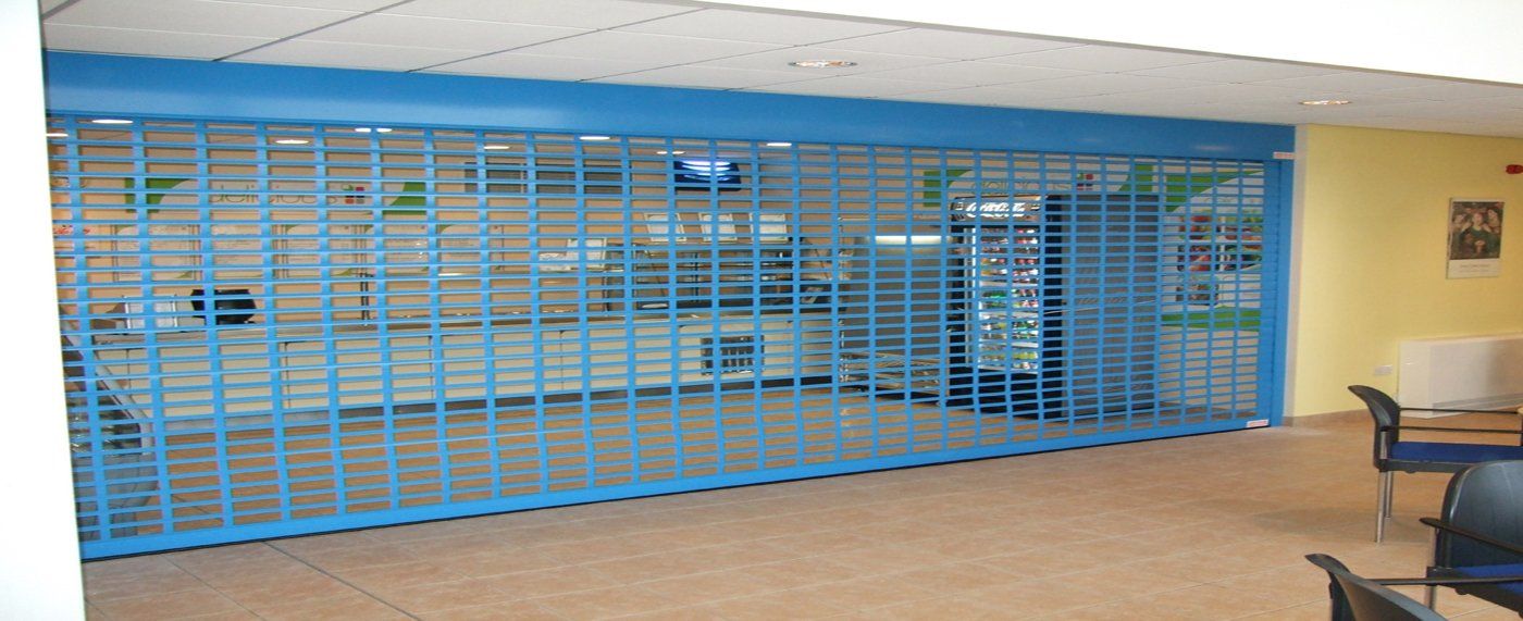 An empty room with a blue sliding glass door