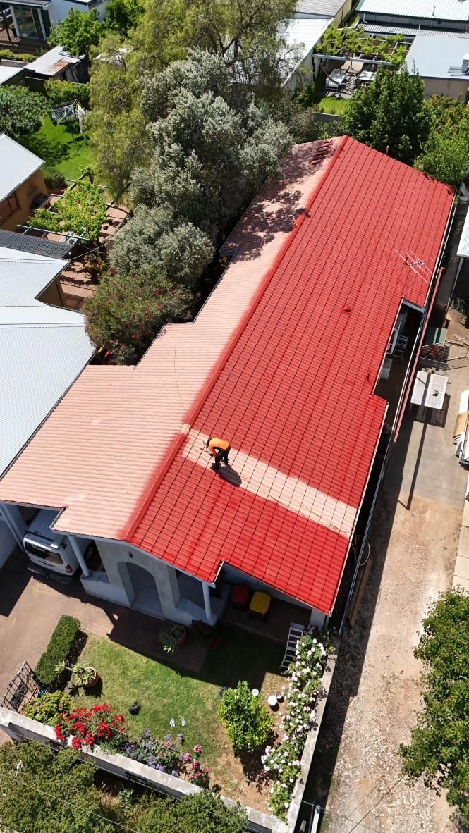 A roof half painted in Adelaide
