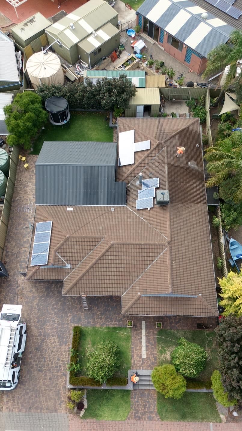 A roof being sprayed clean in Adelaide