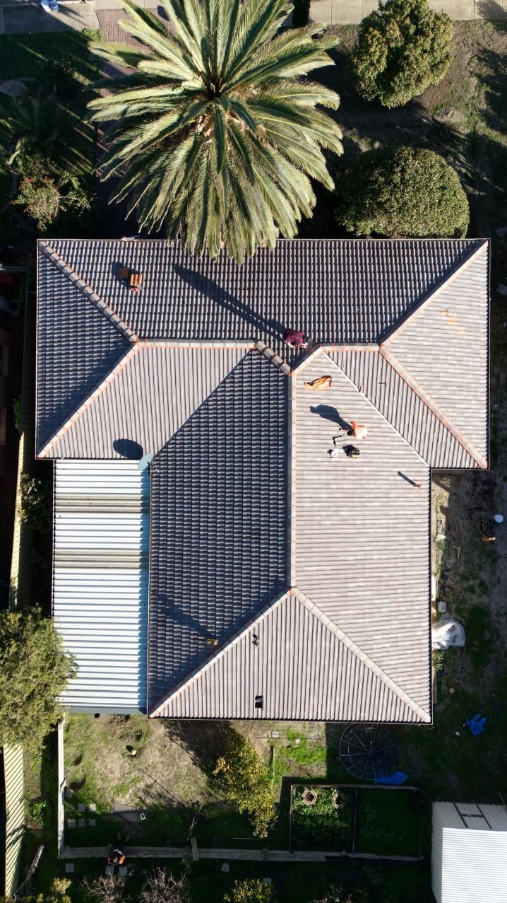 Two people inspecting an Adelaide roof