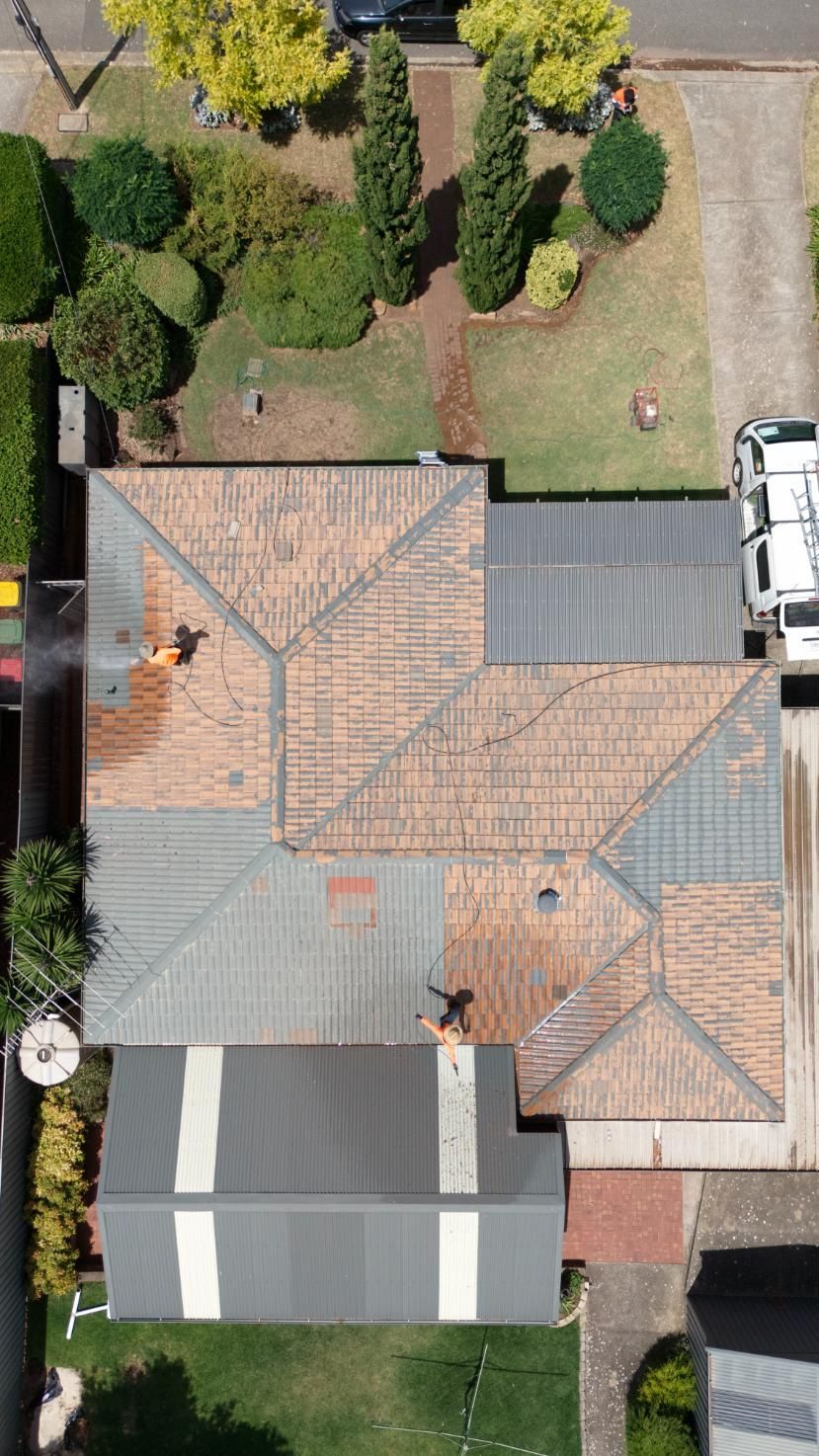 A roof being pressure cleaned in Adelaide