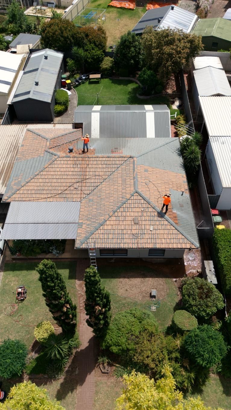 A roof being pressure cleaned in Adelaide