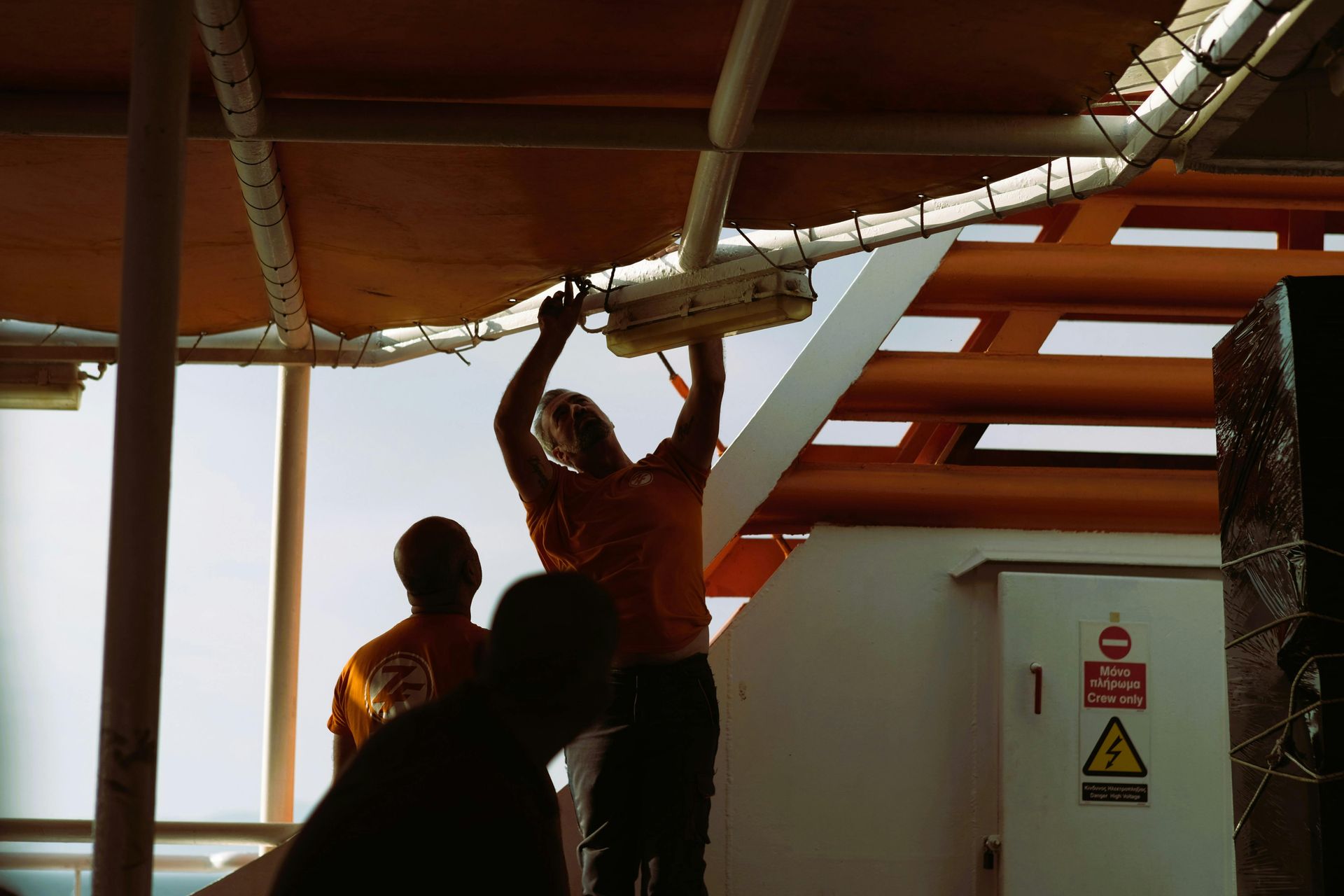 A group of people are working on a boat.