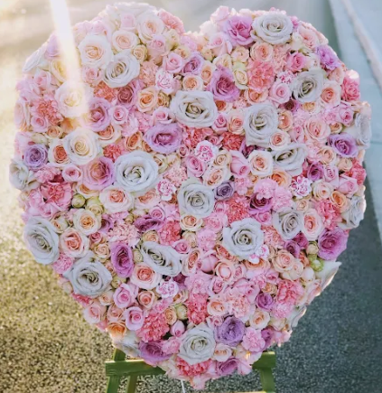 A large heart made of pink and purple flowers
