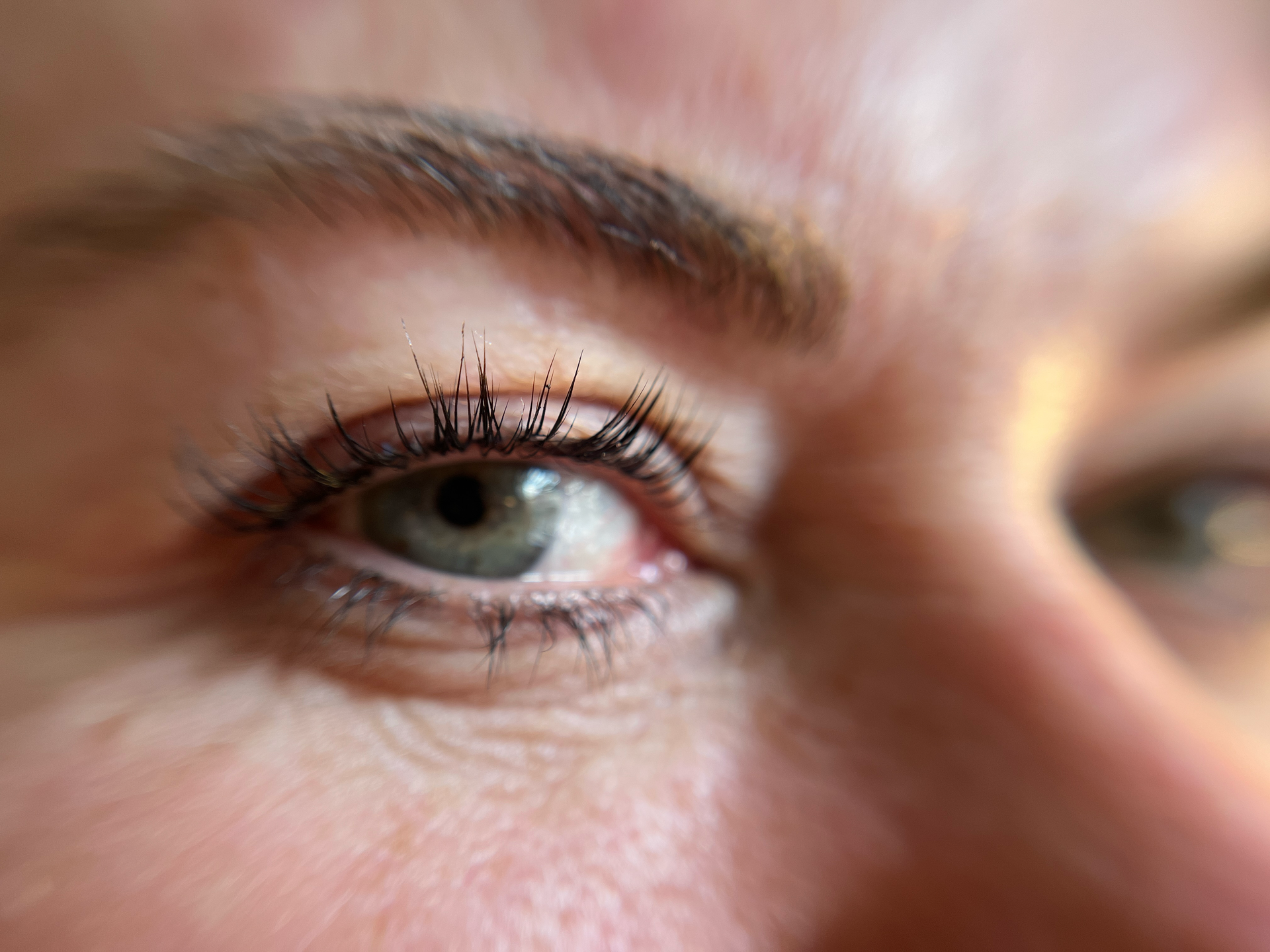 A close up of a woman 's eye and eyebrows.